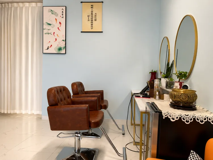 Hair styling area with mirrors and two salon chairs
