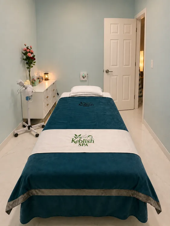 Private massage room with a treatment bed and warm lighting