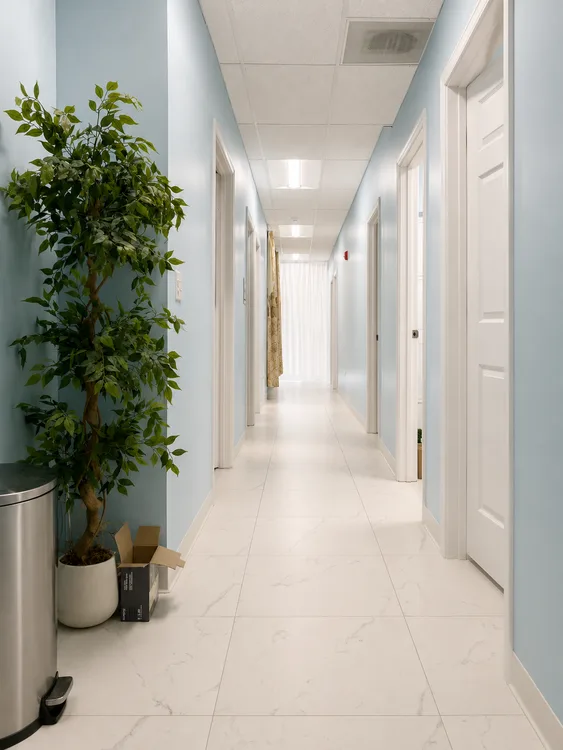 Light blue spa hallway leading to private rooms